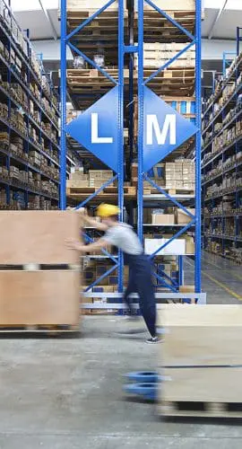 A warehouse scene with workers moving boxes and shelves filled with various items.
